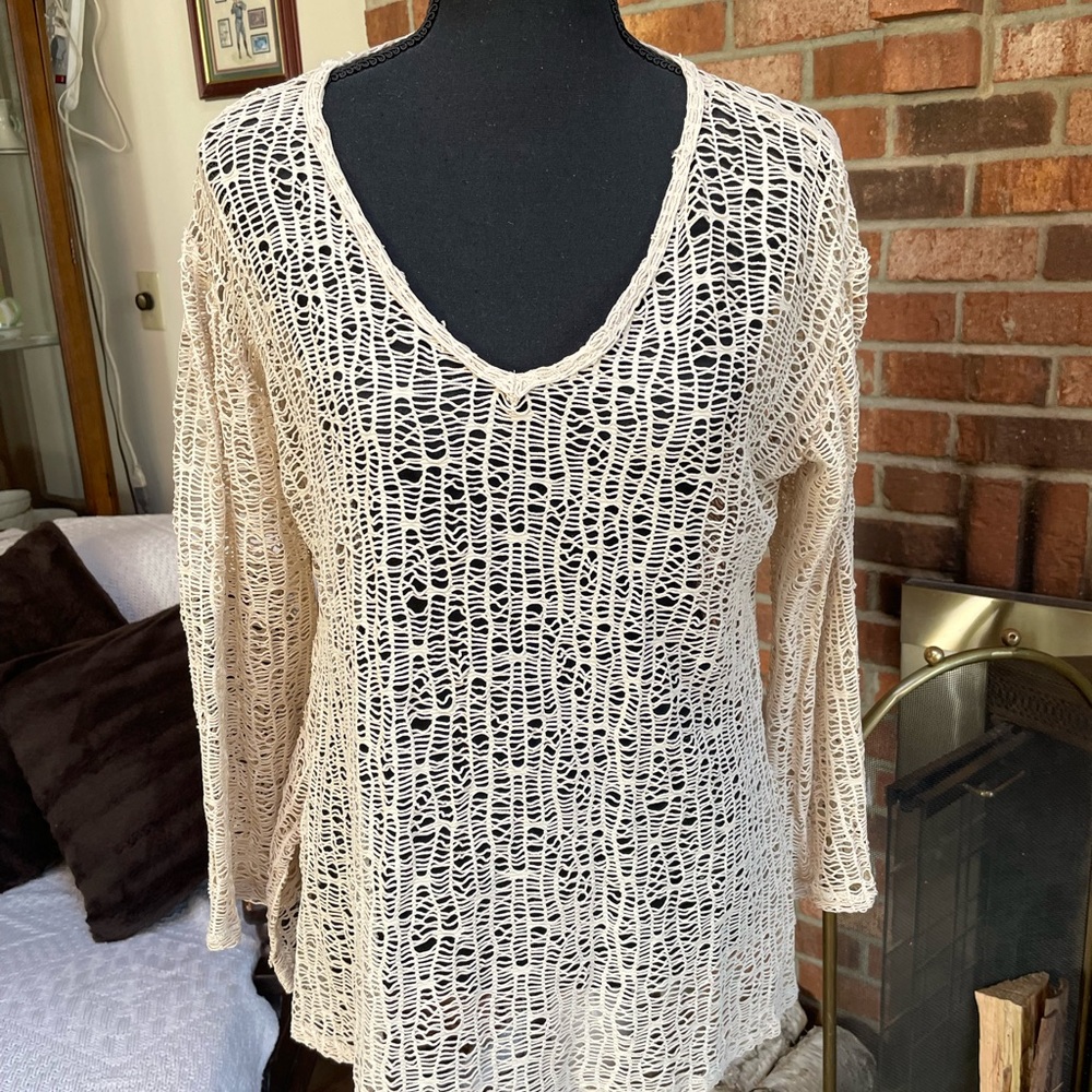 Cream-colored top or bathing suit cover-up